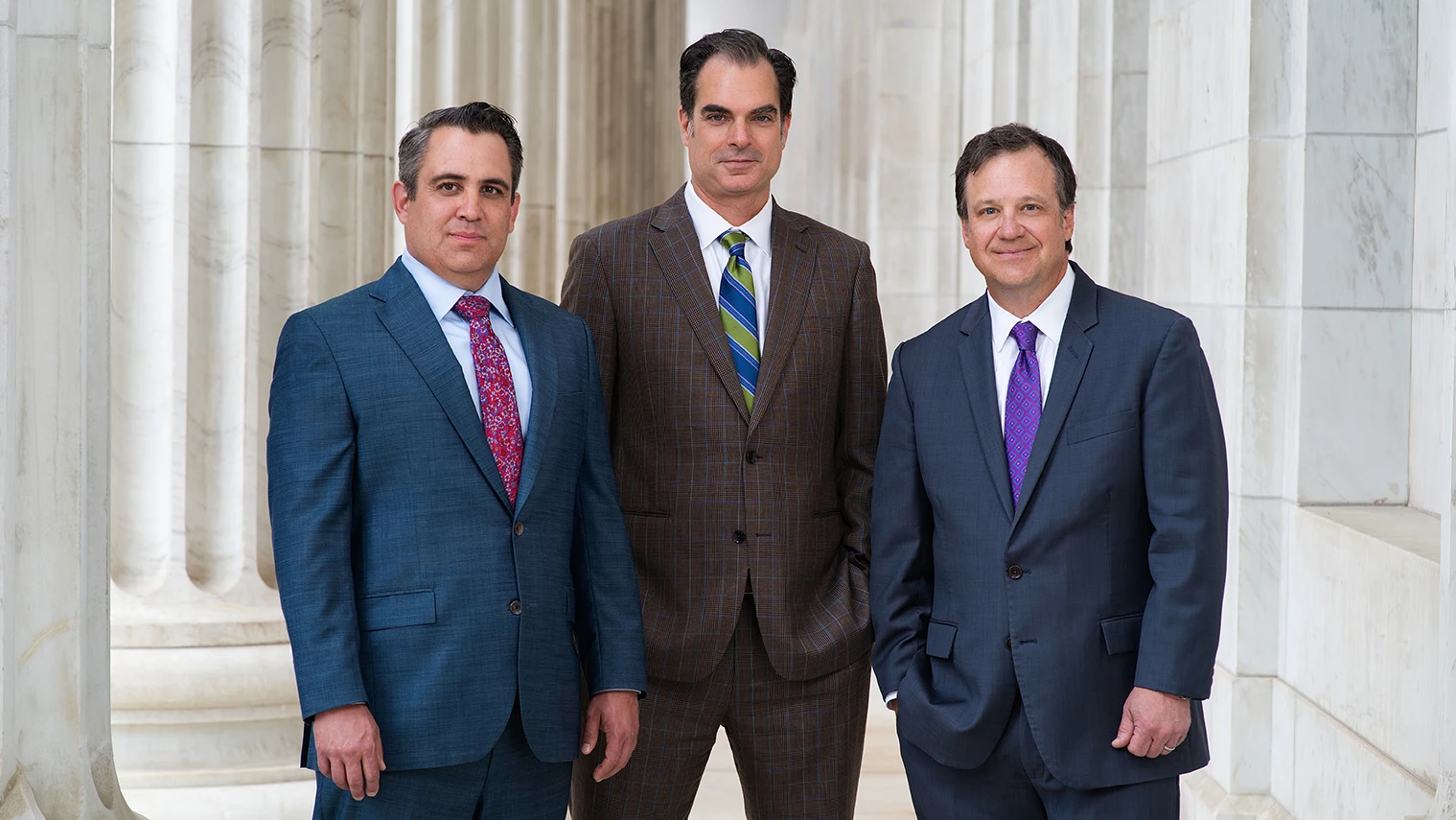 Martin A. Stuart, Thomas R. Ward, and Joshua D. Amos of Stuart & Ward LLP outside a Denver courthouse